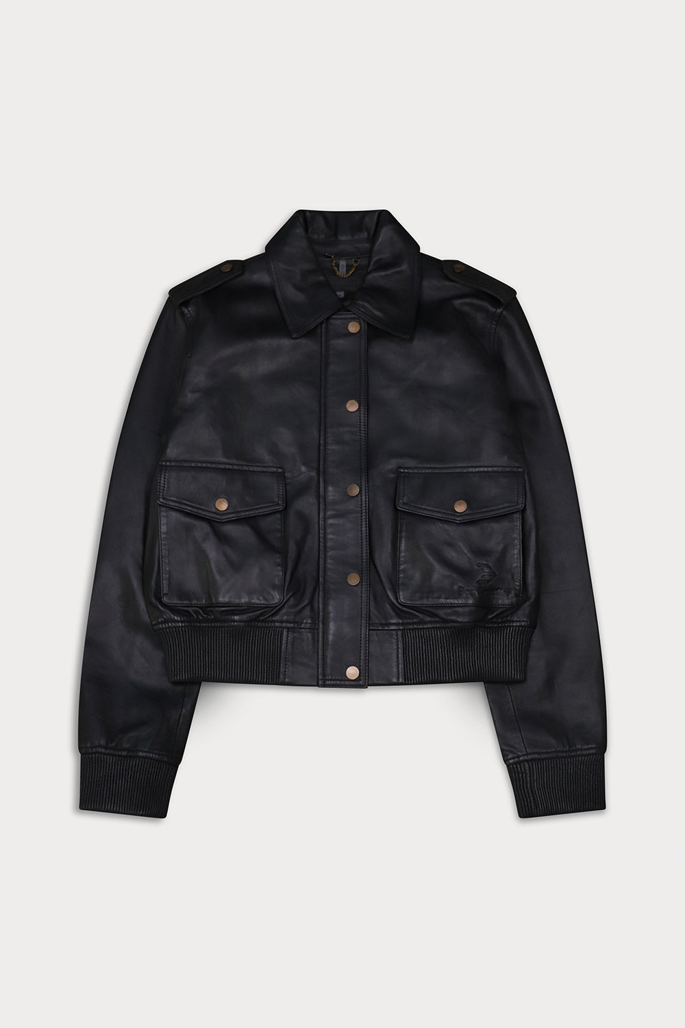 A black leather jacket  button-up front, and two front flap pockets with brass-tone snaps. Amelia -Sly&Co