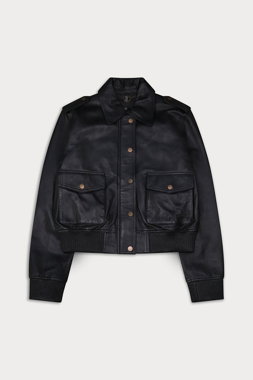 A black leather jacket  button-up front, and two front flap pockets with brass-tone snaps. Amelia -Sly&Co