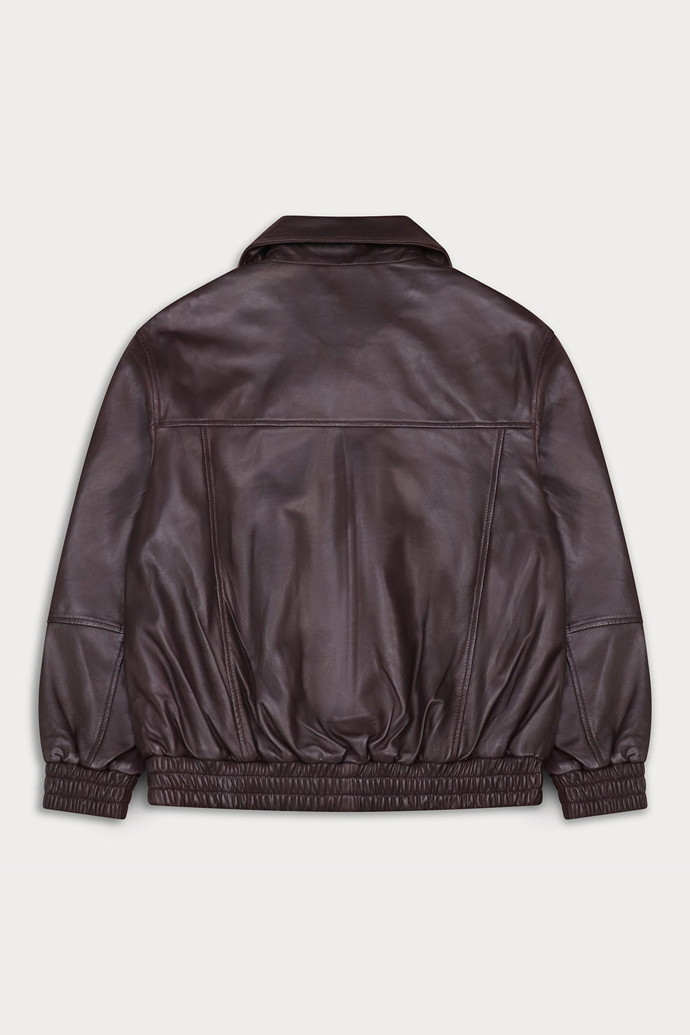 A dark brown leather jacket shown from the back, featuring a collar, front seam detailing, and elasticized cuffs and hem, photographed against a light gray background.