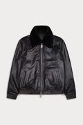 A black leather bomber jacket with a plush black faux-fur collar, ribbed knit trim at the cuffs and hem, and a silver-tone front zipper