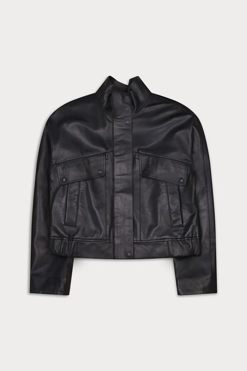 A black leather cropped jacket with a stand-up collar, front button closure, and two large flap pockets on the chest.