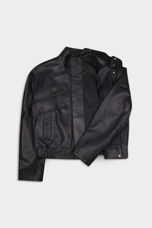 A black leather jacket with a stand collar, flap chest pockets, and snap-button details.
