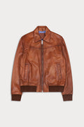 A caramel color leather jacket with a front zipper, pointed collar, and ribbed knit cuffs and hem. City-Sly&Co