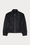 A black leather bomber jacket with a full front zipper, pointed collar, and ribbed cuffs and hem. Ciara- Sly&Co