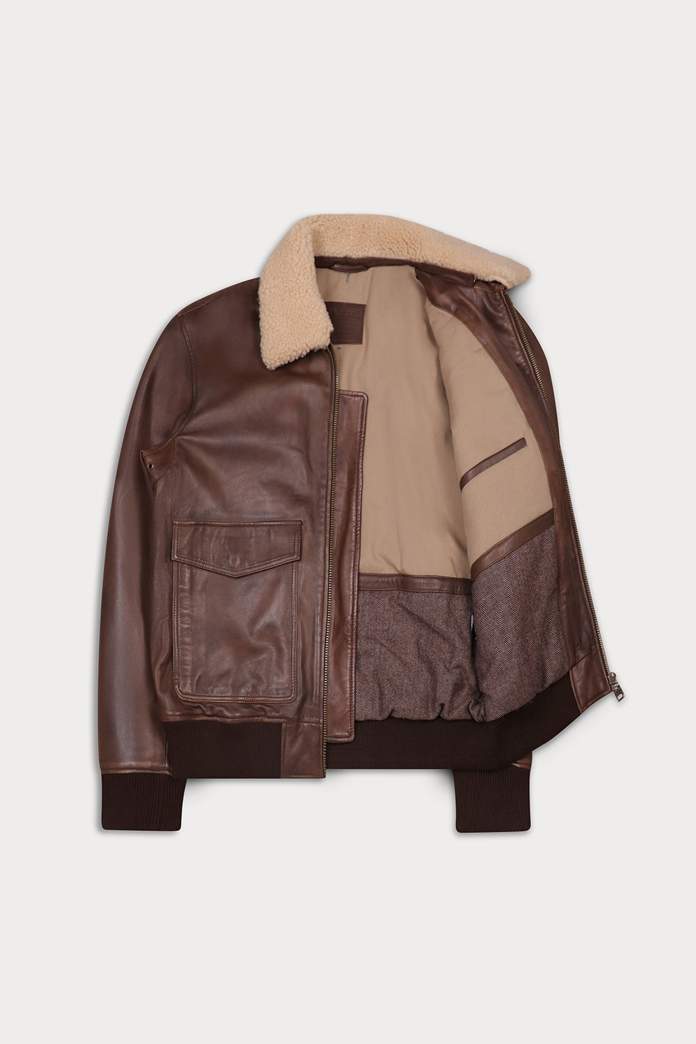 A brown leather aviator jacket with a beige shearling collar, shown open. DFour-SLY&CO
