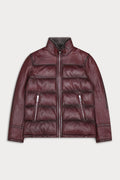 A dark burgundy leather jacket with a quilted puffer body, zippered front and pockets, and a high collar, shown flat against a light gray background.