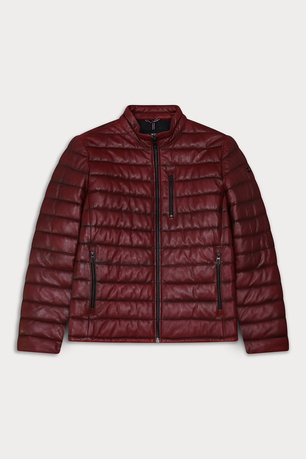 A red quilted puffer jacket with a stand-up collar, front zipper, and zippered pockets. Lewis - Sly&Co.