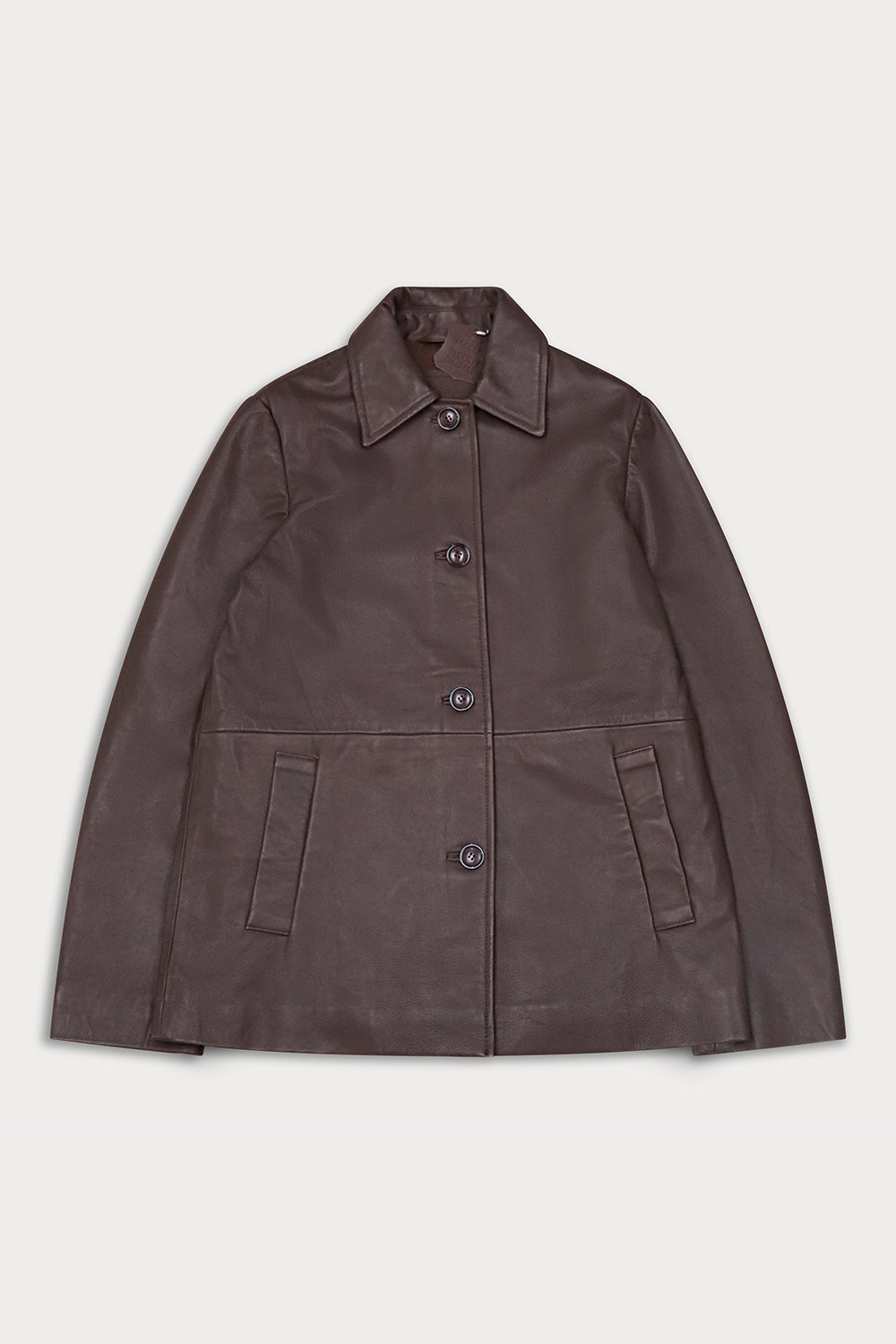 A dark brown leather jacket with a pointed collar, three-quarter button closure, and two front welt pockets, shown flat on a light gray background.