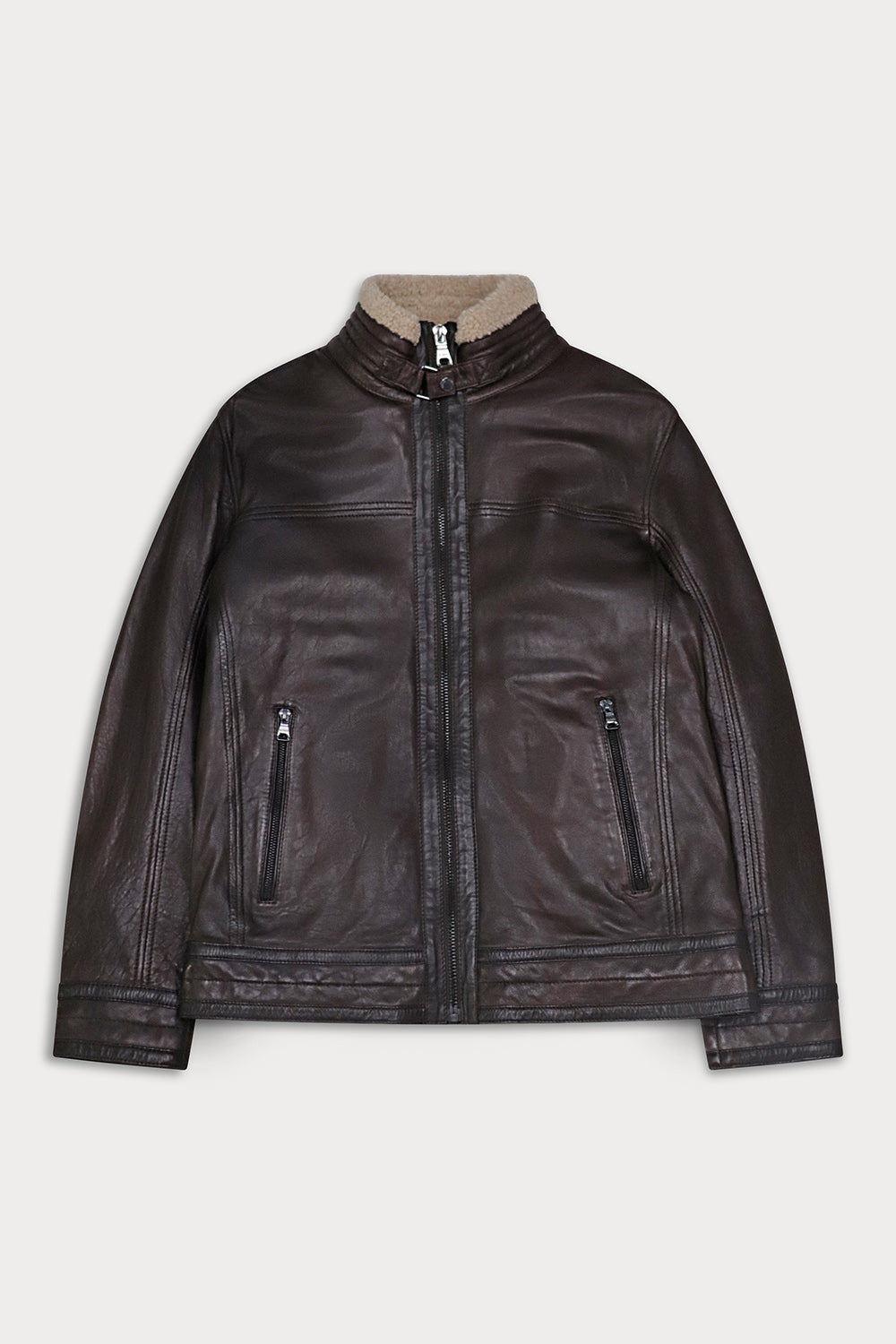 A dark brown leather jacket with a beige sherpa lining visible at the stand-up collar, featuring a front zipper, zippered hand pockets, and ribbed cuffs and hem.