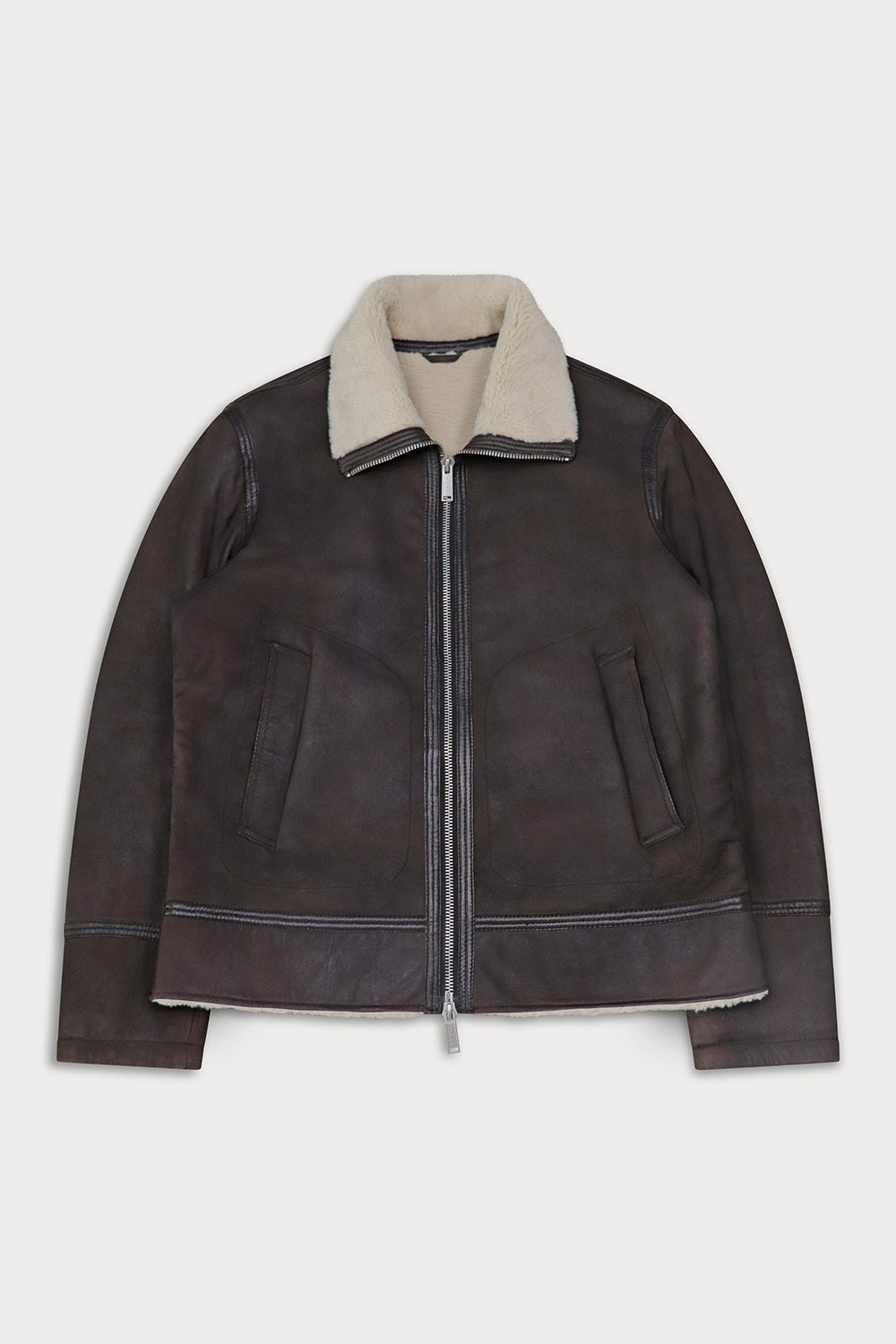 A dark brown suede leather aviator jacket with a beige shearling-style collar. Mukabi-Sly&co
