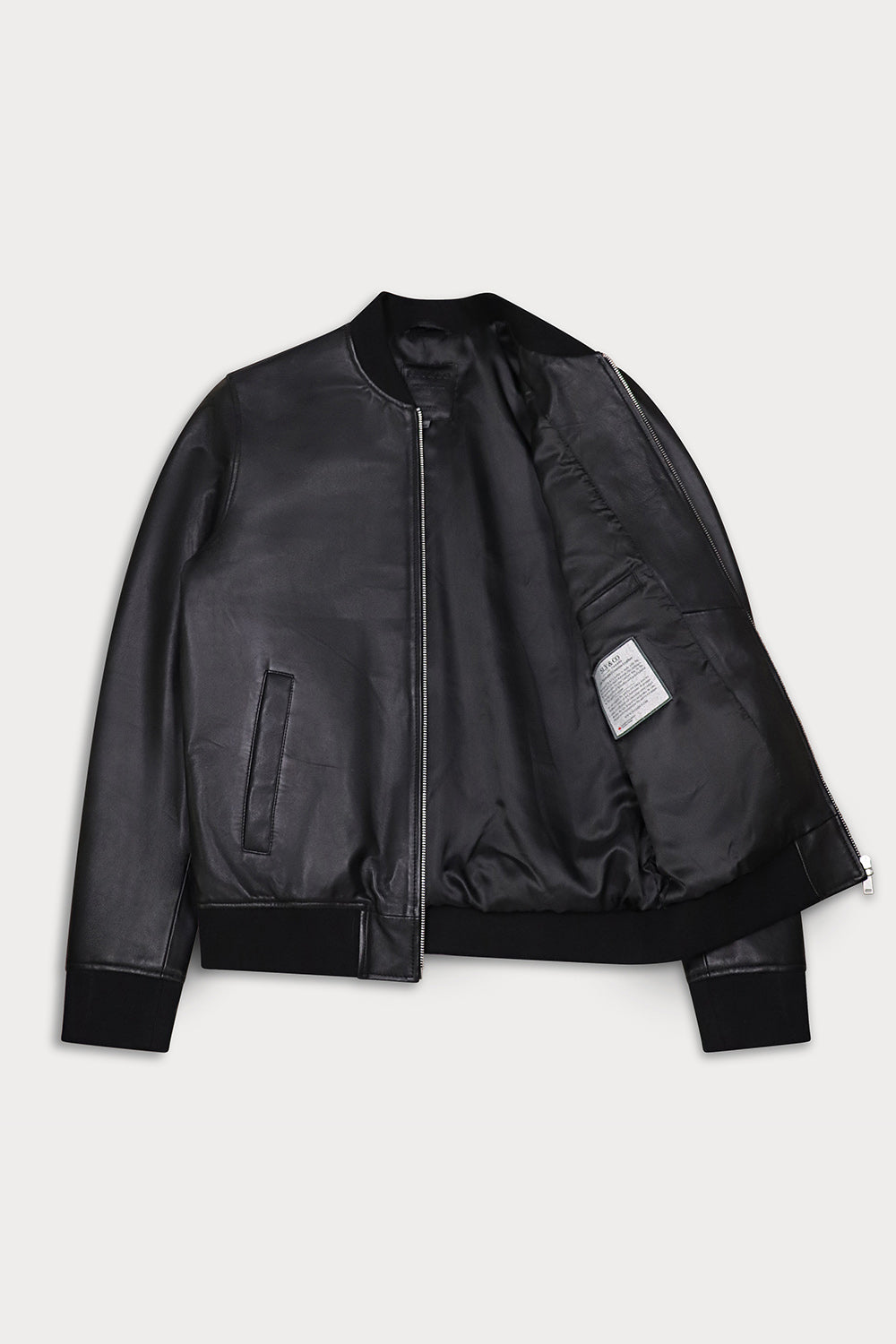 A black leather bomber jacket with a zippered front, ribbed collar, cuffs, and hem, shown open against a light gray background.