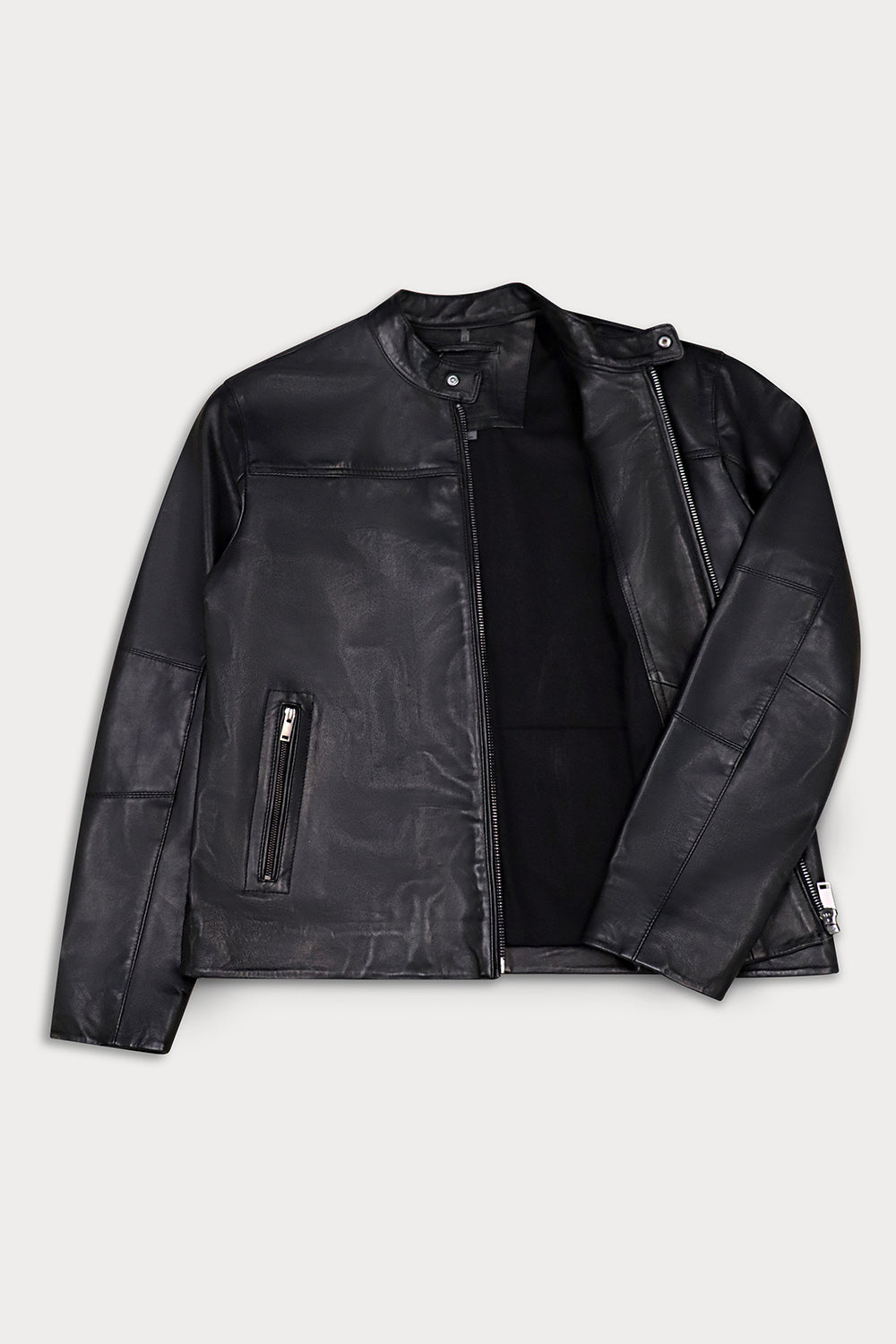 A black leather jacket with a zippered front and side pockets, laid flat against a light gray background.