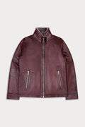 A dark burgundy leather jacket with a high collar, front zipper, and two vertical zippered pockets.
