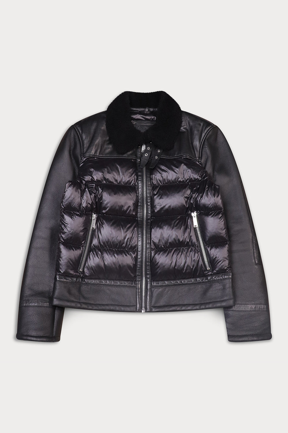 A cropped black leather jacket with a quilted puffer front, zippered pockets, and a black fur collar