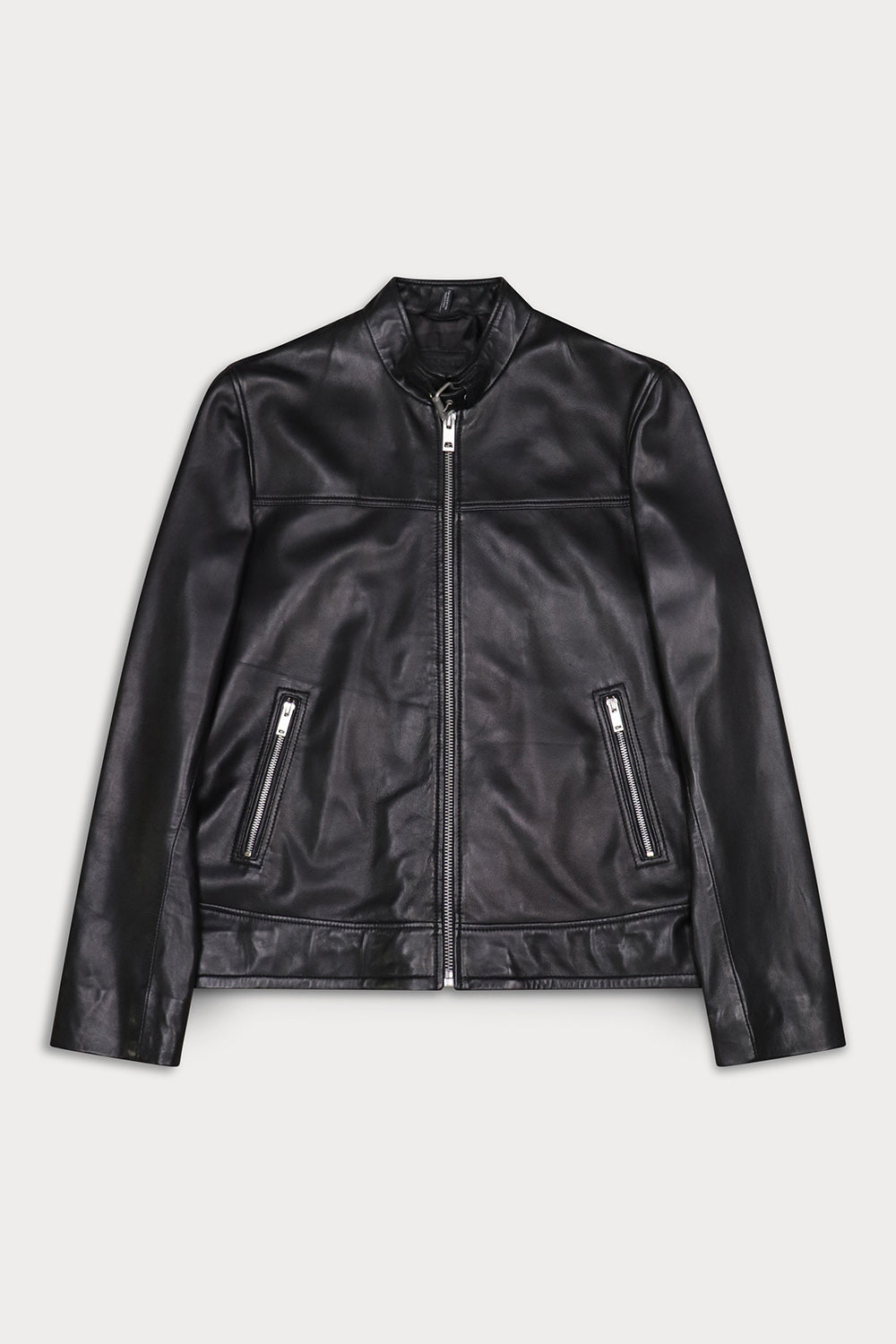 A black leather jacket with a front zipper, stand collar, and two zippered hand pockets. Vespa from Sly&Co