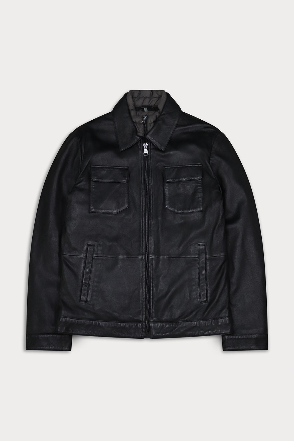 A black leather jacket with a zippered front, collar, two chest flap pockets, an interior vest. Sandro-Sly&Co