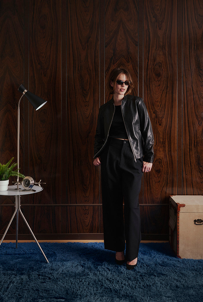 A model wearing a black leather jacket, from Sly&Co