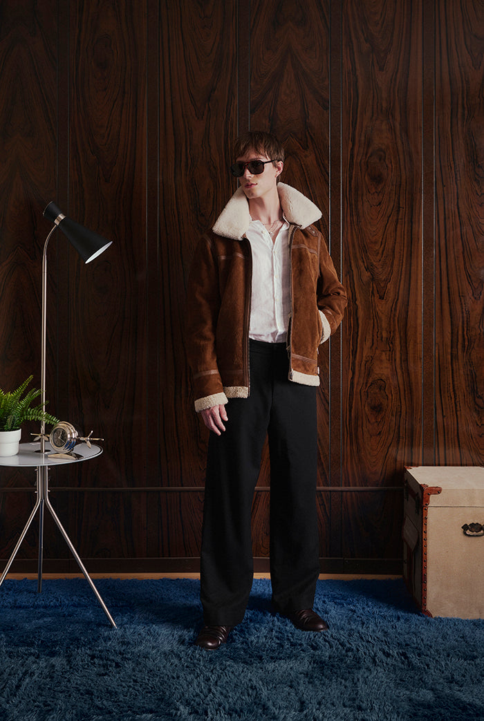 A man wearing a brown shearling-lined jacket from Sly&Co
