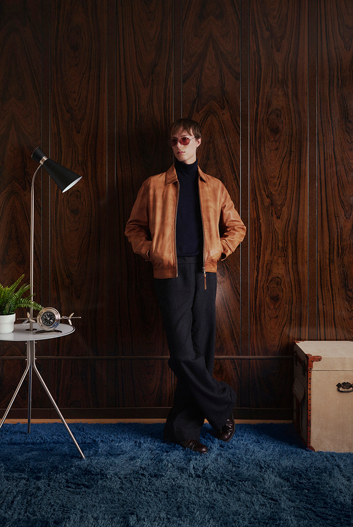 A model wearing a tan leather jacket from Sly&Co.
