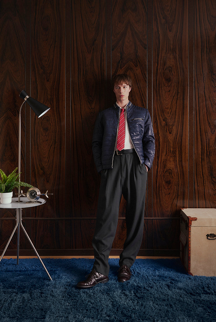 Leman in navy on a model  is a quilted jacket in a semi-fitted cut from Sly&Co.