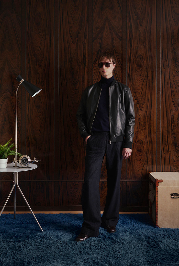 A model wearing a black leather jacket from Sly&Co.