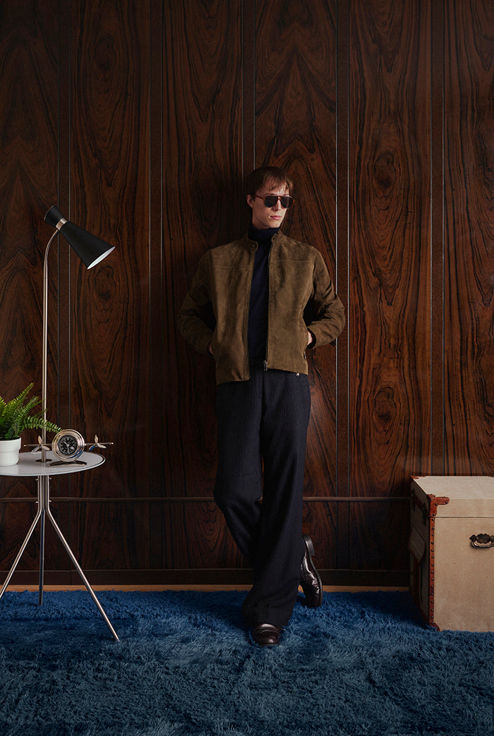 A man wearing an olive suede jacket, from Sly&Co