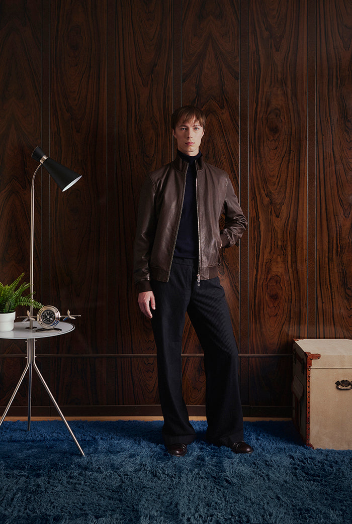 A male model  wearing a brown leather jacket, Sorrento, from Sly&Co.